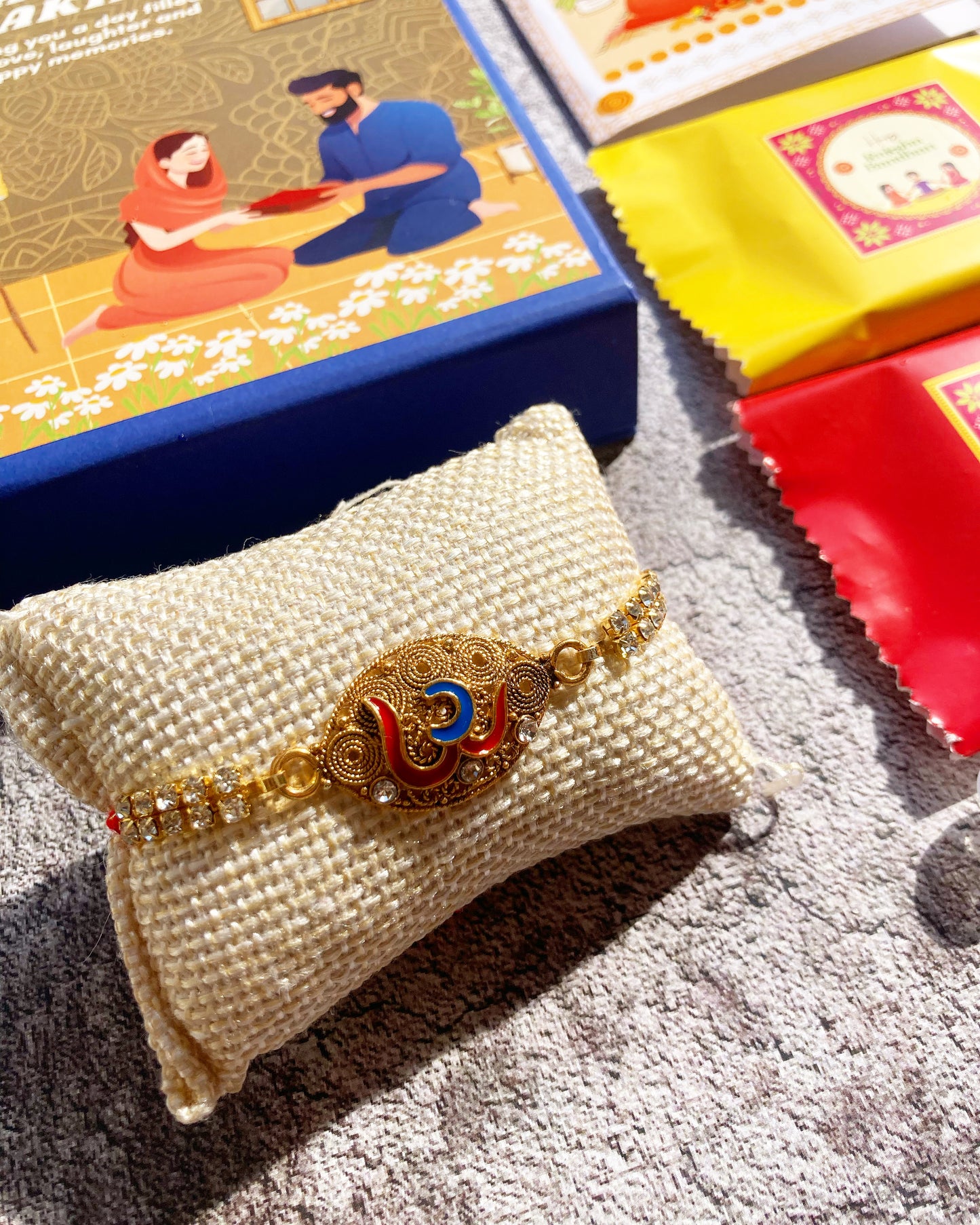 Om Kundan Rakhi for Brother| Magnetic Gift Box, Chocolates, Card, Roli & Chawal